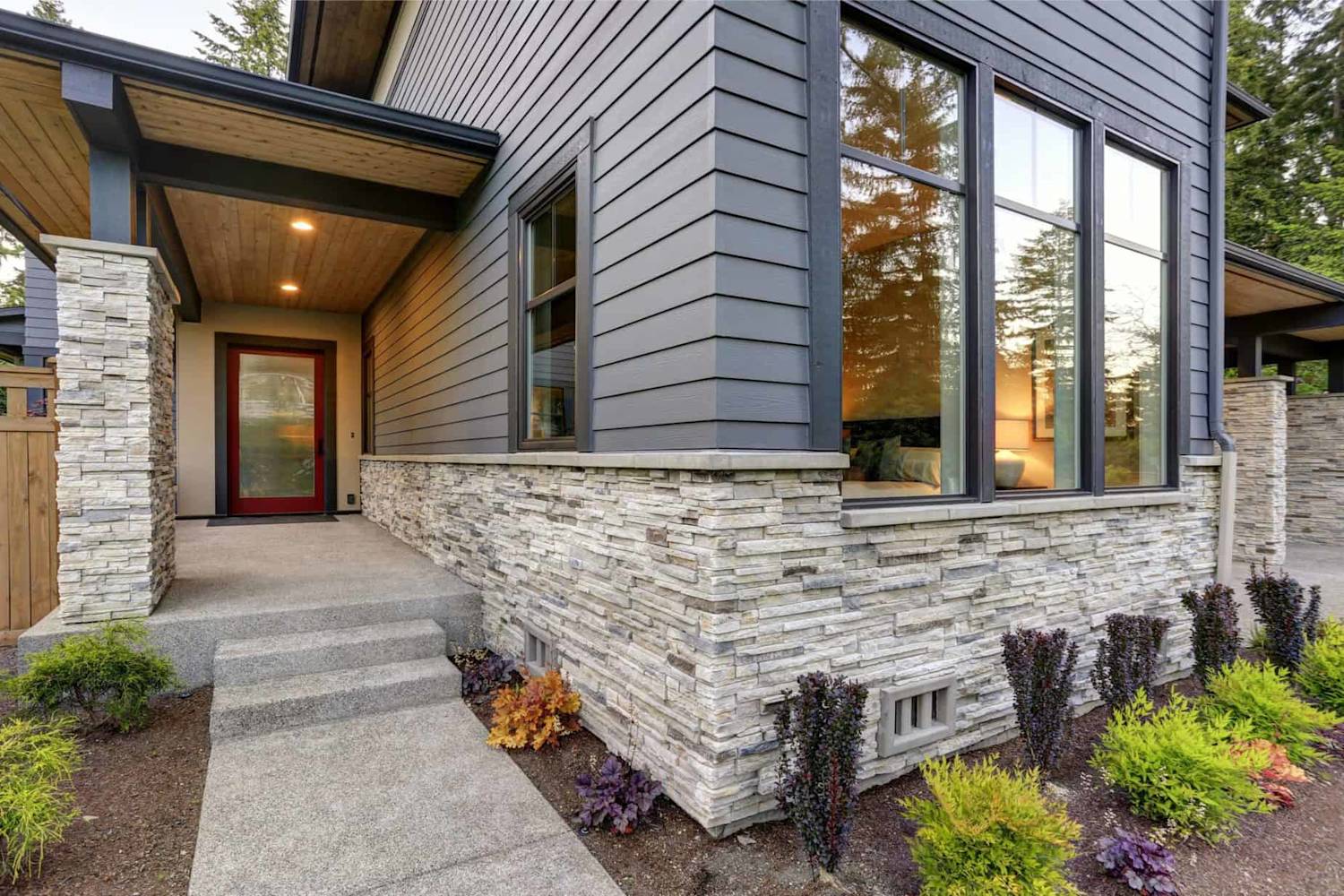 Modern house with beautiful grey siding and stone veneer